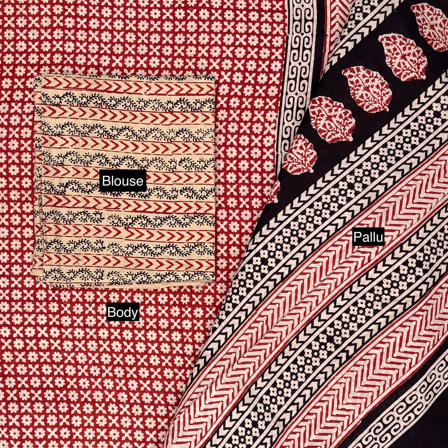 Red base colour saree with small beige booti block print all over with a contrasting beige colour blockprinted blouse material. Pallu on display. 