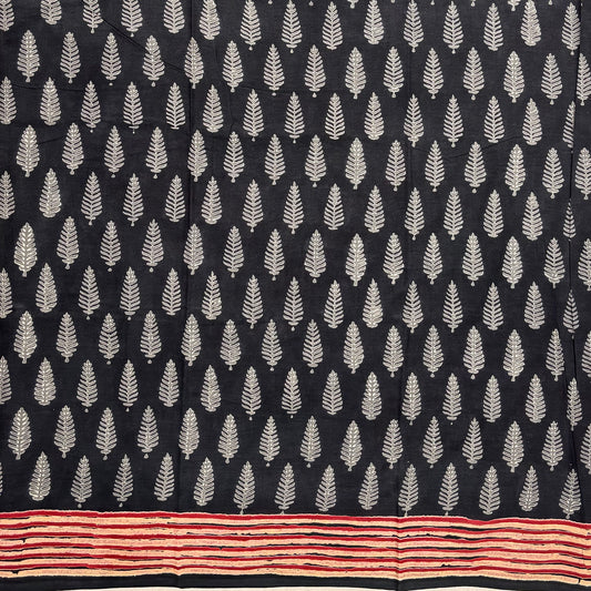 Charcoal grey base cotton saree with white leaf booti block print and red border.