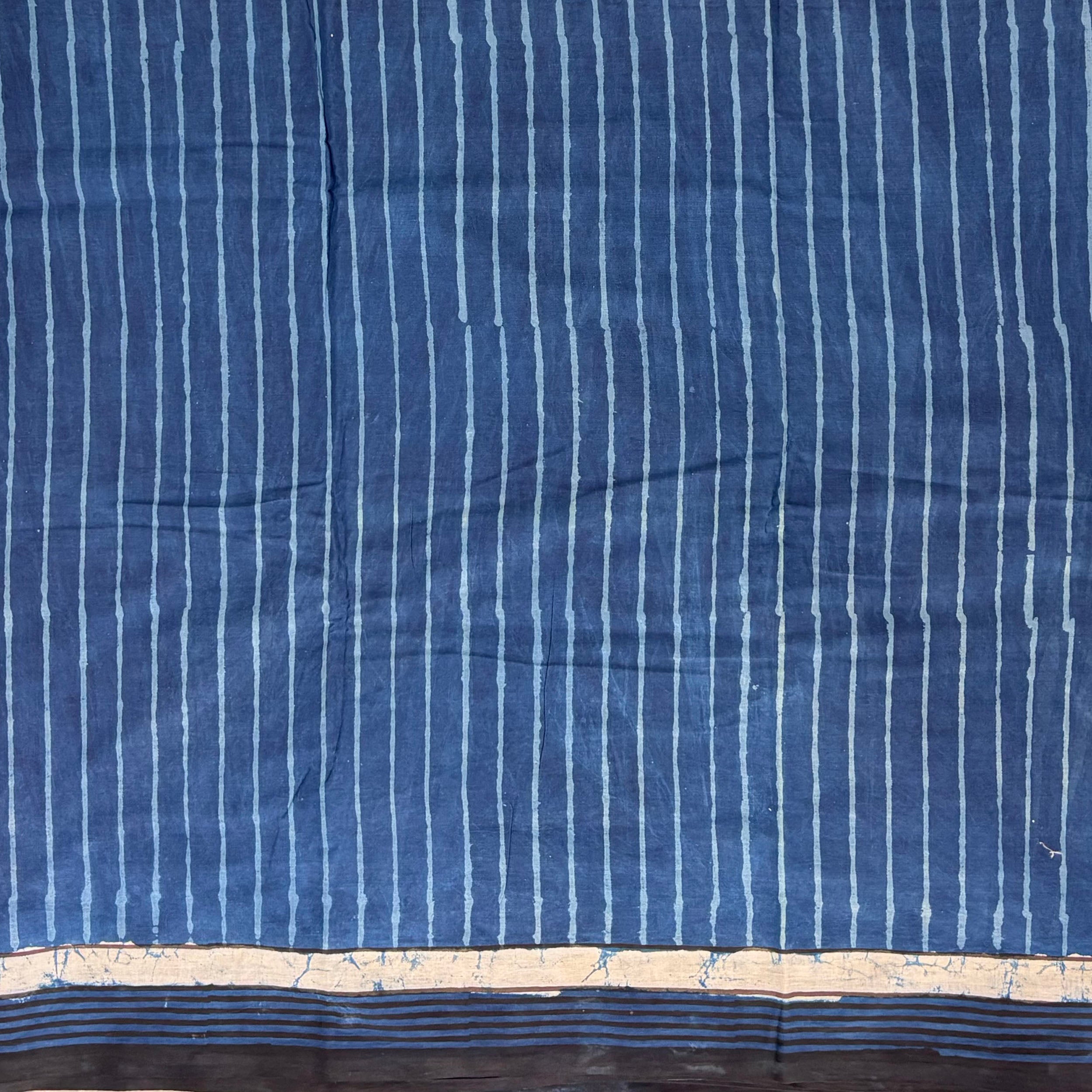 Indigo colour cotton saree with blockprinted stripes.